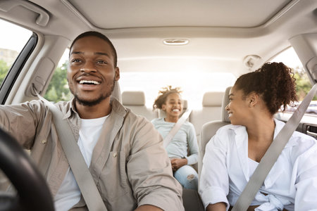 Black Parents And Daughter Sitting In Auto During Road Tripの写真素材