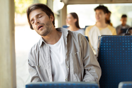 Portrait of tired guy sleeping in bus