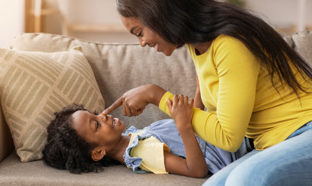 Mother and Daughter Share Moments of Joy While Playing Together at Home in the Afternoonの写真素材