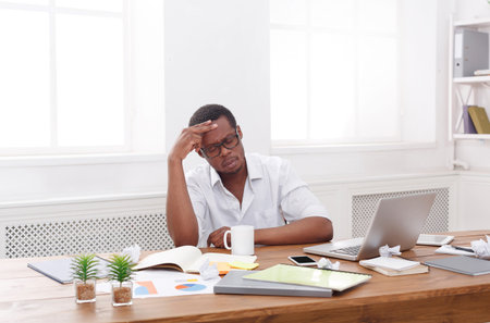 Pensive african-american employee at workplace