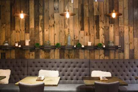 Cozy Cafe Interior With Wooden Accents and Plush Seating for Relaxed Gatheringsの写真素材