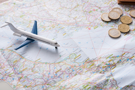 Exploring Travel Options With a Model Airplane on a Detailed Map and Coins
