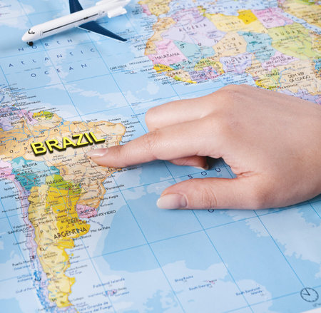 Woman hand choosing Brazil country for summer trip