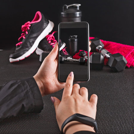 Capturing a Moment of Fitness Preparation With Phone and Workout Gear in a Gym Space