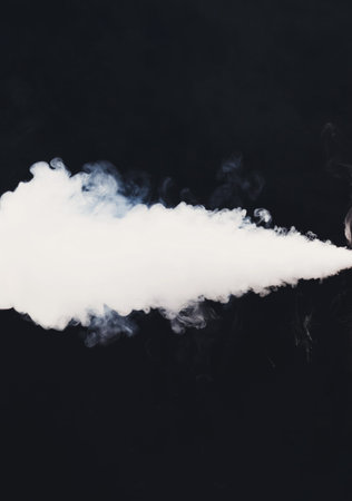 Smoke Billows From a Source in a Dark Setting Creating a Striking Visual Effectの写真素材