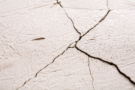 Cracks Visible on a White Surface With Texture and Pattern During Daylightの写真素材