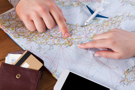 Planning a Travel Route With a Map and Travel Essentials in a Cozy Environment