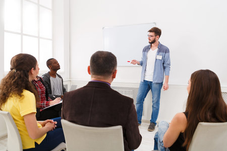 Group Session Discussing Topics With a Speaker in a Bright Room