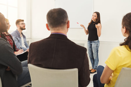 Group Listens to a Speaker During a Presentation in a Bright Meeting Room