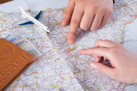 Planning a Trip With a Map, Passport, and Small Plane Toy on the Table in a Travel Setting