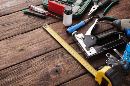Tools Spread on Wooden Surface for Various Tasks in Workshop Setting During Daytime
