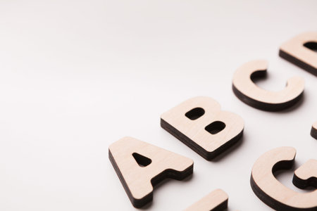 Different Shaped Wooden Letters on a White Surface During a Creative Activity