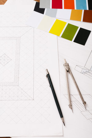 A Collection of Sketches and Color Samples is Spread on a Table