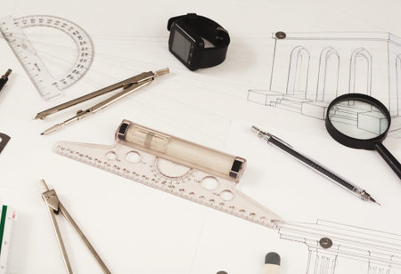 Collection of Drafting Tools and Sketches Arranged in a Mosaic on a Work Surface
