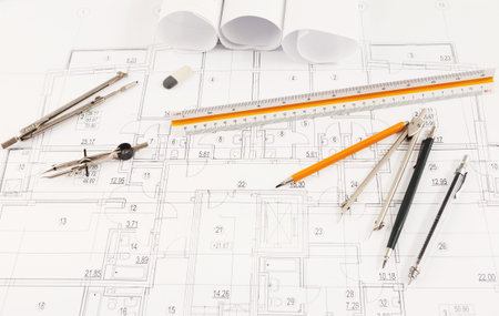 Collage of Drafting Tools and Architectural Plans on a Workspace During a Design Project