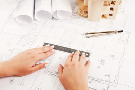 Designing a Building With Blueprints and Tools Laying on the Table