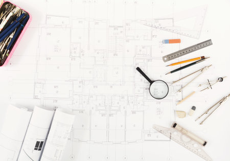 Collection of Architectural Tools and Plans on a Desk for Building Design and Drafting Work