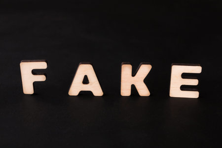 Wooden Letters on Dark Background in Studio Setup During Daytime
