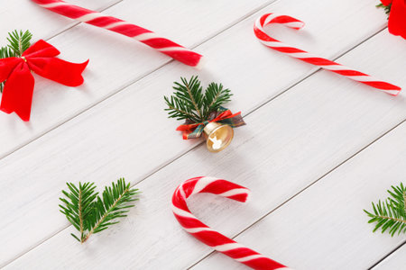 Festive Collage of Candy Canes and Decorations on White Wooden Background During Holiday Season