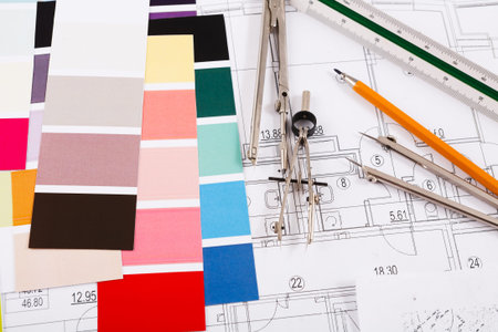 Collage of Color Swatches, Drafting Tools, and Design Plans on a Table