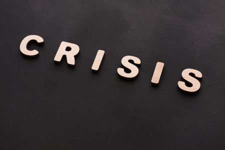 Letters Spell Crisis on a Dark Surface in a Simple Display