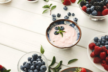 Mosaic of Fresh Fruits and Yogurt in a Simple Collection on Wooden Tableの写真素材