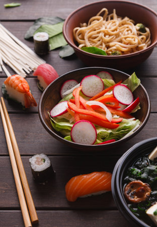 Collage of Various Japanese Dishes Arranged on a Wooden Table for a Colorful Display of Flavorsの写真素材
