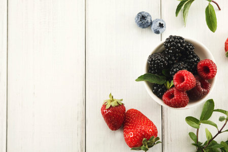 Colorful Fruit Collage on a Wooden Table With Various Berries in a Bowl
