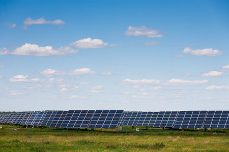 Solar Panels in a Green Field Under Blue Sky During Daylight Hours in a Rural Area