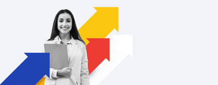 A Woman in a Suit Holds a Clipboard and Smiles While Standing in Front of Arrows