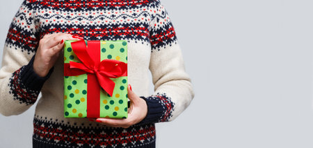 Gift Giving During Holiday Celebration in Cozy Sweater With Festive Design