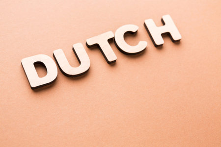 Wooden Letters Spelling out Dutch on a Brown Background Showing a Simple Design