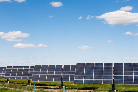 Solar Panels on a Field Under a Bright Blue Sky With Clouds During Daytime