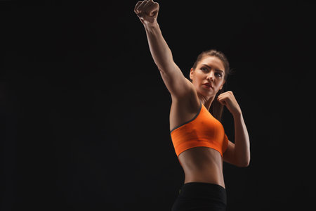 Woman Practicing Boxing in a Training Studio During Evening Hours