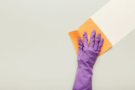 Cleaning Process Using a Sponge on a Flat Surface With a Gloved Hand in a Simple Setting
