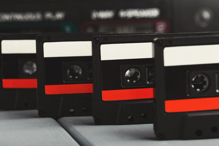 Collection of Cassette Tapes Arranged in a Mosaic Style on a Wooden Table