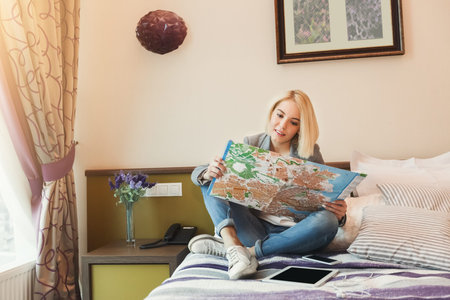 Exploring a Travel Map in a Hotel Room During the Daytime While Planning a Trip