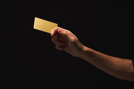 Cards Held in Hand Against Dark Background Showing Texture and Color Variations
