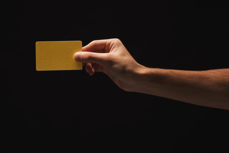 Hand Holds Yellow Card on Dark Background in a Simple Collage Set