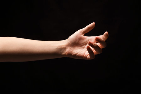 Hand Reaching out in a Dark Space Creating a Visual Connection Within a Mosaic Collage