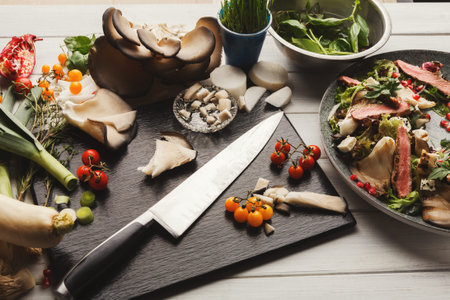 Different Vegetables and Mushrooms Arranged With Knife on a Wooden Table for Cooking Activityの写真素材