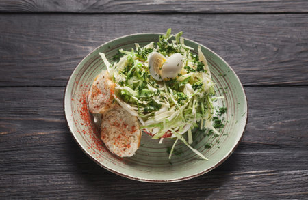 Fresh Salad With Boiled Eggs and Herbs on a Rustic Wooden Table During Lunchtimeの写真素材