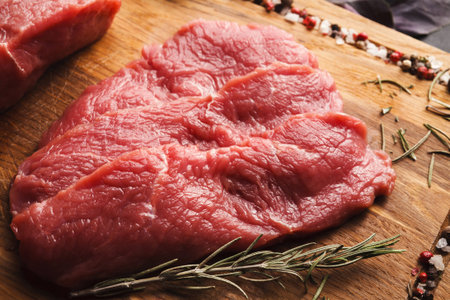 Collage of Meat Cuts on Wooden Board With Spices and Herbs Arranged for Culinary Display