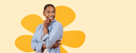 Woman Smiles and Poses in Studio With Orange Pattern Behind Her While Wearing Casual Blue Shirt