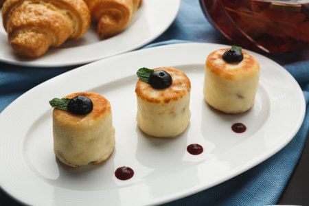 Delicious Collection of Pastries on a Plate With Fresh Fruits and Sauces