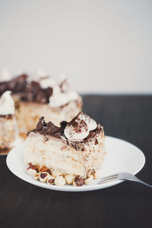 Collage of Dessert Pieces Including Chocolate Cake Presented on a White Plate With Nuts
