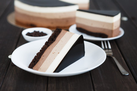 Slices of Layered Dessert Are Placed on White Platesの写真素材