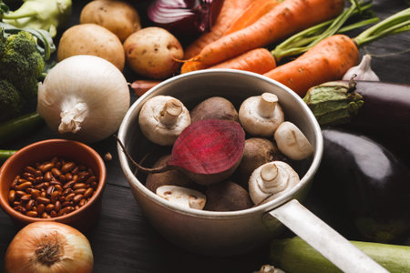 Collection of Fresh Vegetables in a Cooking Set Arranged on a Dark Kitchen Tableの写真素材