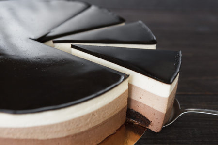 Delicious Cake With Layers of Chocolate and Cream Served at a Dessert Gatheringの写真素材