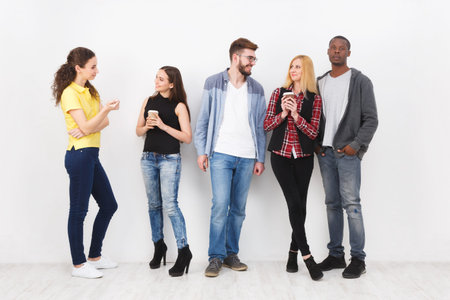 Friends Interacting and Enjoying Drinks Together in a Bright Indoor Settingの写真素材